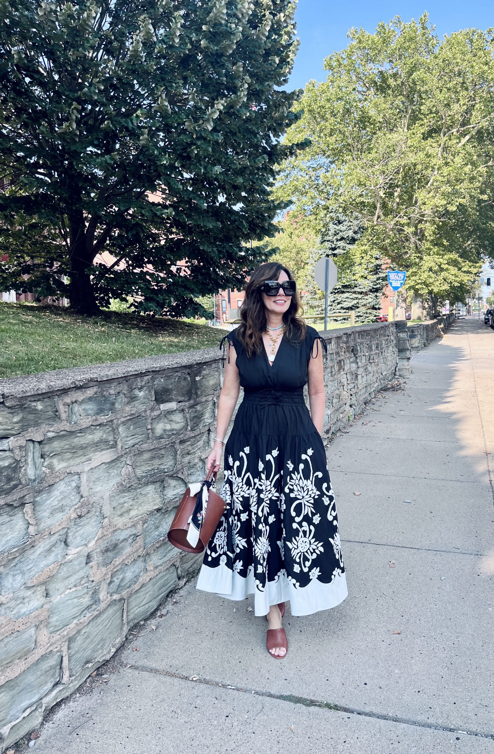 Rose Hayes wearing 10 Crosby black dress with brown bucket bag and brown Joie Wedges. She shoes hoew to mix brown and black.